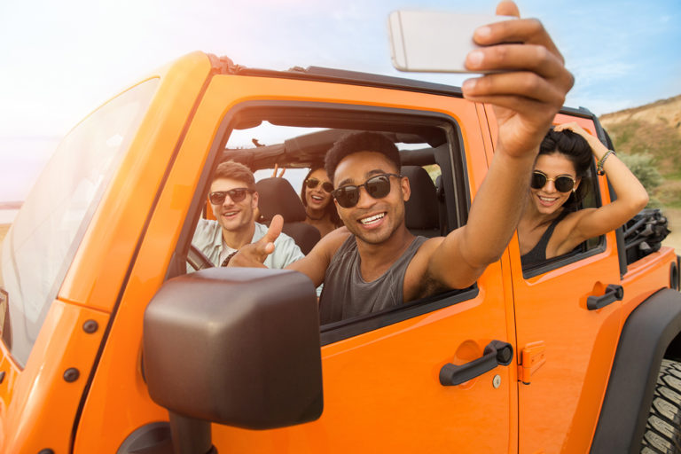 Group of happy young friends taking a selfie