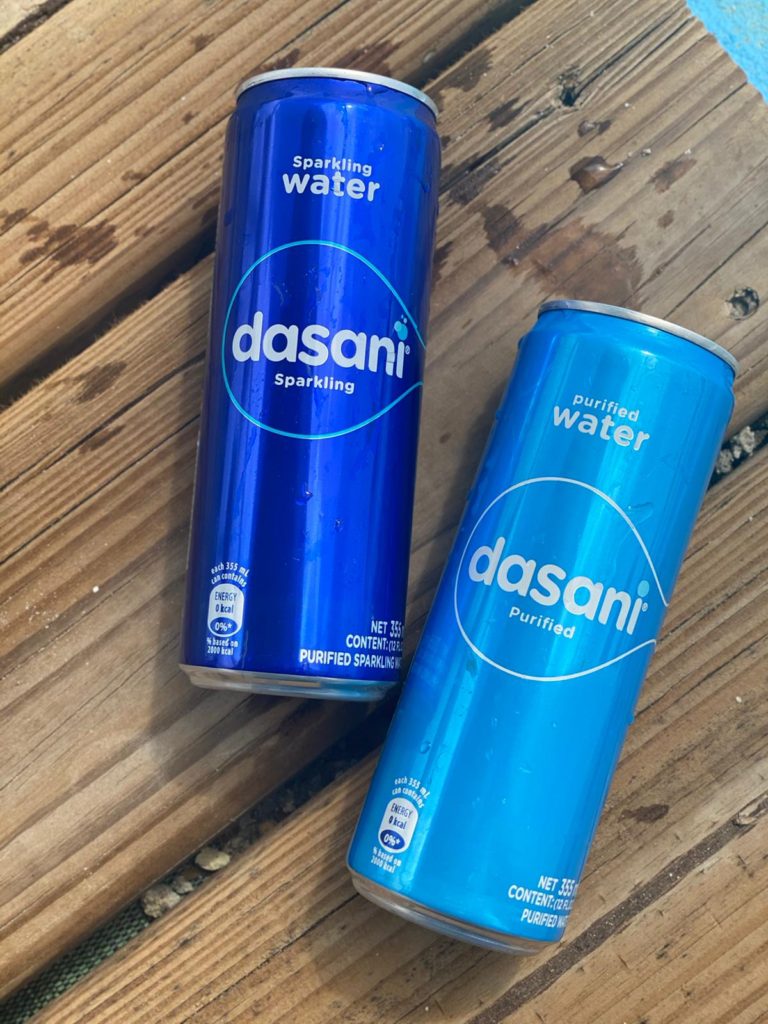 0 Dasani cans on wooden table