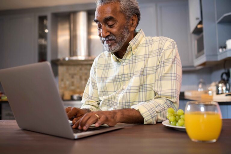Smiling man using laptop